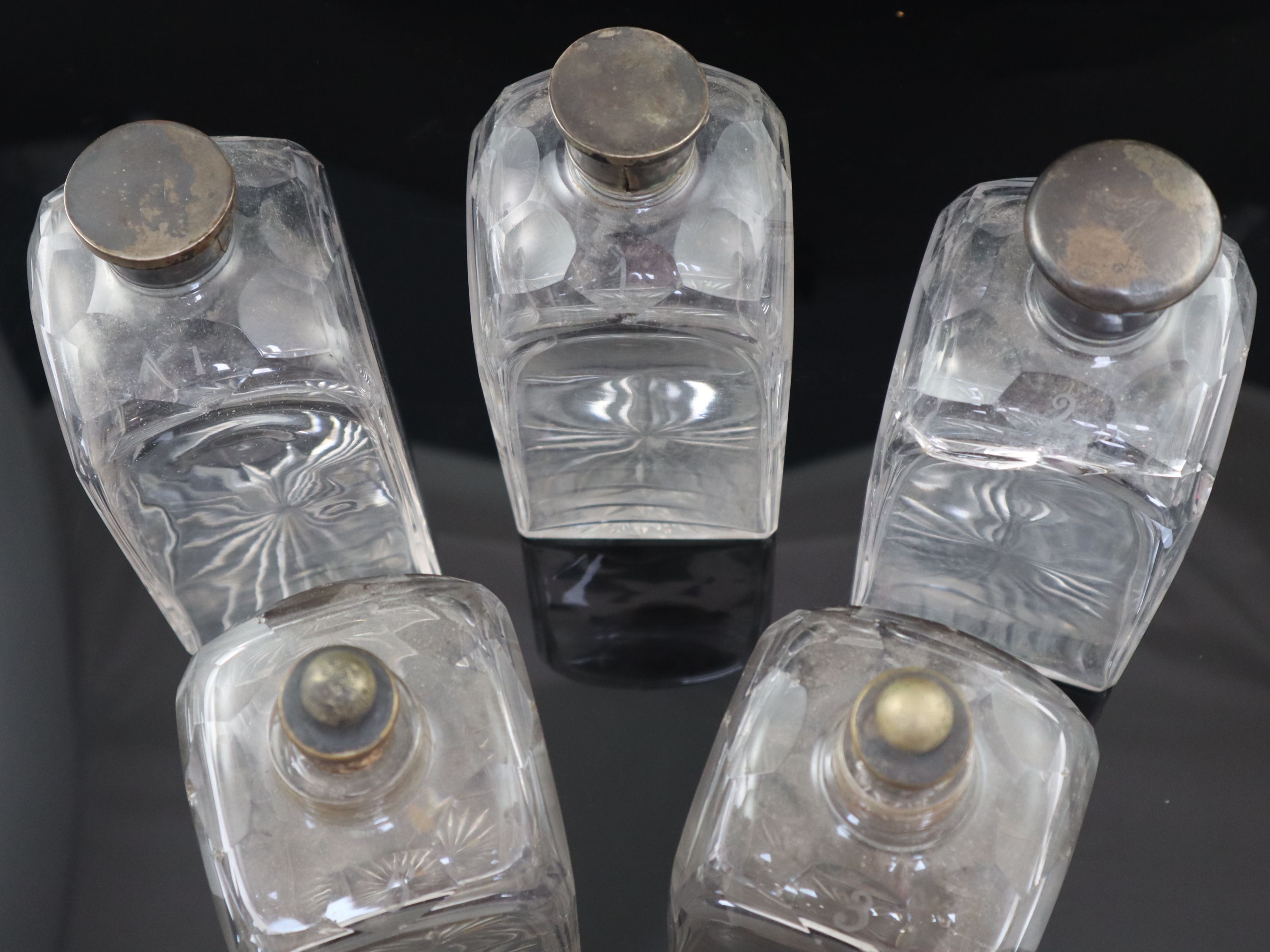 A part set of five early 19th century cut glass decanters, 23cm